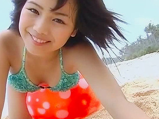 Rion Sakamota plays with a ball on the beach